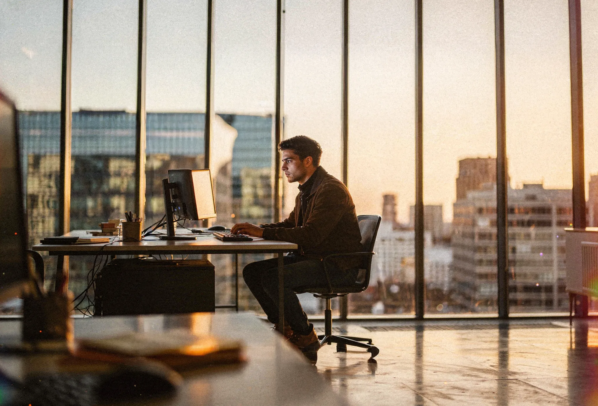 Talent working at a modern desk with city skyline view